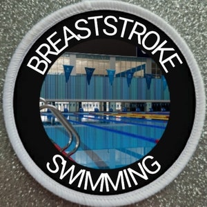 May include: A black and white round patch with the words "BREASTSTROKE SWIMMING" in white text around a photo of a swimming pool.