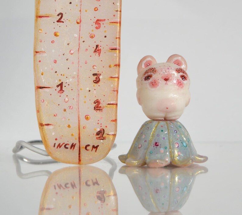 Little Cute Teddy Bear With Bushy Eyebrows Standing on a Calyx