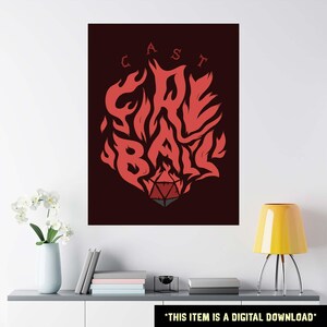 May include: A digital download poster with a dark red background. The poster features the words "CAST FIRE BALL" in a stylized, fiery font. A red and gray D20 die is at the bottom of the design. The text "THIS ITEM IS A DIGITAL DOWNLOAD" is at the bottom.