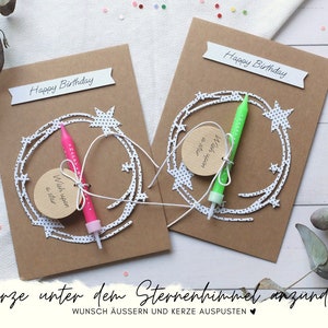 May include: Two brown cardstock birthday cards with a white star design and a small candle. The text on the cards reads "Happy Birthday" and "Wish upon a star".