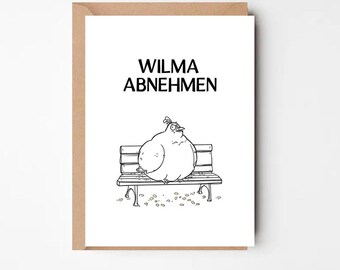 May include: A greeting card with a brown border features a black and white cartoon of a large bird sitting on a park bench. The text "WILMA ABNEHMEN" is printed above the bird. The card is on a white background.