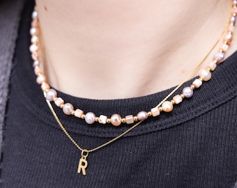 Zoetwaterparelketting met roestvrijstalen frame en schelpparels, parelketting in roze en paars.