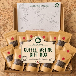 May include: A coffee tasting gift box containing twelve numbered kraft paper pouches filled with coffee beans. The box includes a map titled Around the World in 12 Coffees and a central label reading Barista Cats COFFEE TASTING GIFT BOX.