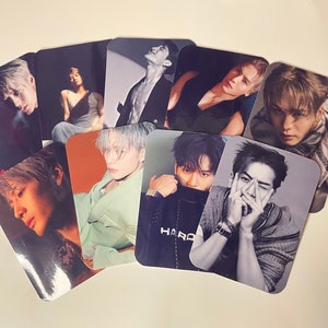 May include: A collection of glossy photo cards featuring various portraits of a person with light-colored hair. The cards display different poses and outfits, with some in black and white and others in color.