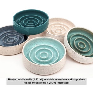 May include: Five round ceramic bowls with concentric interior rings. Colors include teal, dark blue, light blue, and cream with speckles. The text states: Shorter outside walls (2.5" tall) available in medium and large sizes. Please message us if you're interested!