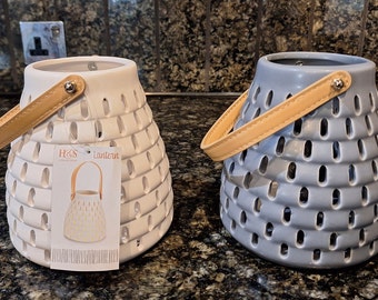 Ceramic lanterns with cut out pattern with Leather Straps.