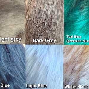 May include: Close-up of six different faux fur fabric swatches. Colors include light grey, dark grey, teal blue, dark blue, light blue, and white with black tips. Each swatch has a soft, textured appearance.