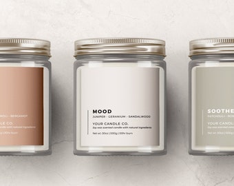May include: Three glass candle jars with silver lids and labels. The labels are white with black text. The candles are labelled "Calm", "Mood", and "Soothe". Each label lists the scent notes and the brand name "Your Candle Co."