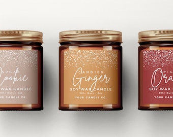 May include: Three glass candle jars with gold lids and labels. The labels have a glittery background and white text. The scents are Sugar Cookie, Candied Ginger, and Spiced Orange. Each candle is a soy wax candle and burns for 30 hours.