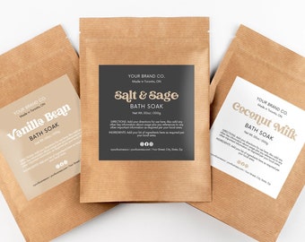 May include: Three brown paper pouches with white labels containing bath soak products. The labels have black text and the product names are "Vanilla Bean", "Salt & Sage", and "Coconut Milk".
