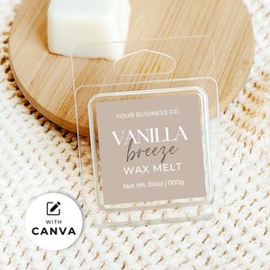 May include: A clear plastic package containing a vanilla-scented wax melt. The label reads "VANILLA breeze WAX MELT" in a stylish font. The background includes a wooden surface and a soft, textured fabric. The text "YOUR BUSINESS CO." is also visible.