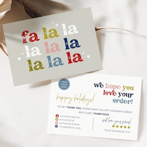 May include: Two holiday-themed cards. One card features the phrase "fa la la la" in colorful text on a light gray background. The second card says "We hope you love your order!" and "happy holidays!"