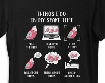 May include: Black t-shirt with a white graphic of a pink cockatoo and the text "Things I do in my spare time". The graphic shows the cockatoo feeding, researching, looking at, talking about, thinking about, and dreaming about other cockatoos.