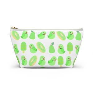 May include: A white zippered pouch with a repeating pattern of green parrots, green pears, green popsicles, and yellow donuts with pink sprinkles.