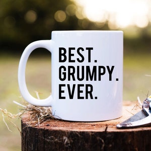 May include: White ceramic mug with a black handle. The mug has the text "BEST. GRUMPY. EVER." printed on it.
