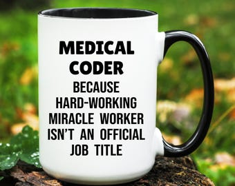 May include: White ceramic mug with a black interior and handle. The mug features the text "MEDICAL CODER BECAUSE HARD-WORKING MIRACLE WORKER ISN'T AN OFFICIAL JOB TITLE" in bold black letters.