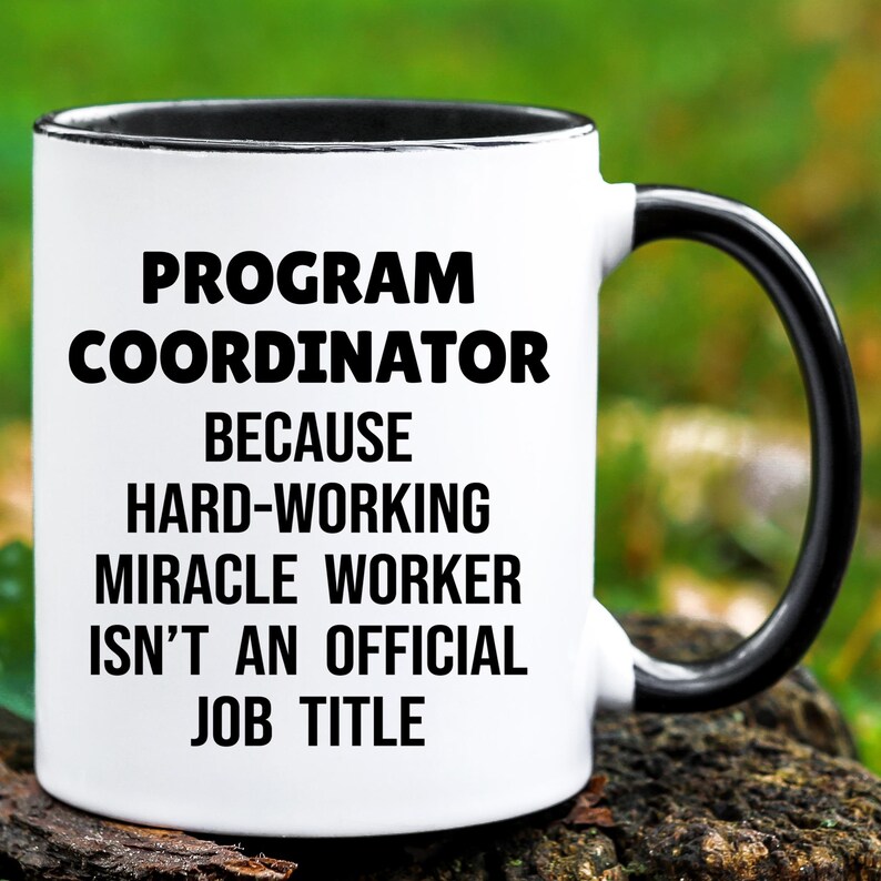 May include: White ceramic mug with a black interior and handle. The mug features the text "PROGRAM COORDINATOR BECAUSE HARD-WORKING MIRACLE WORKER ISN'T AN OFFICIAL JOB TITLE" in black, bold font.