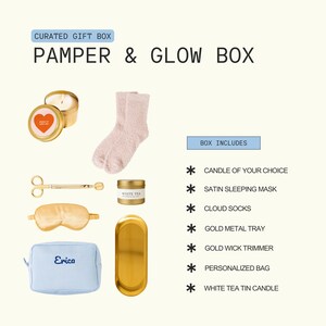 The image is a gift box containing various items, including a candle, a pair of fuzzy socks, a white tea tin, and other personal care products.