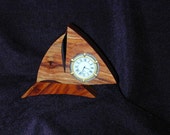 Sailboat clock in highly figured and colored Tulipwood. 4 quot H x 5.5 quot W. Nautical bezel with roman numeral face.
