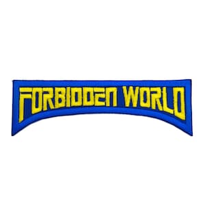 May include: A blue embroidered patch with the words "FORBIDDEN WORLD" in yellow block letters. The patch has a curved shape and a blue border, with the text centered.