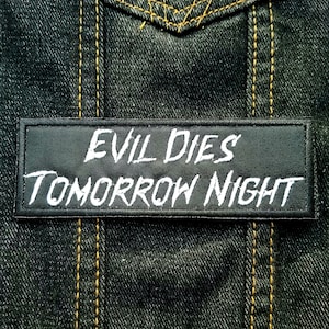 May include: Black patch with white text that reads "Evil Dies Tomorrow Night".