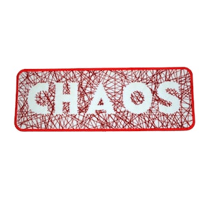May include: A rectangular patch with the word "CHAOS" in white block letters. The letters are set against a background of red intersecting lines, all within a red border. The patch has a clean, modern design.