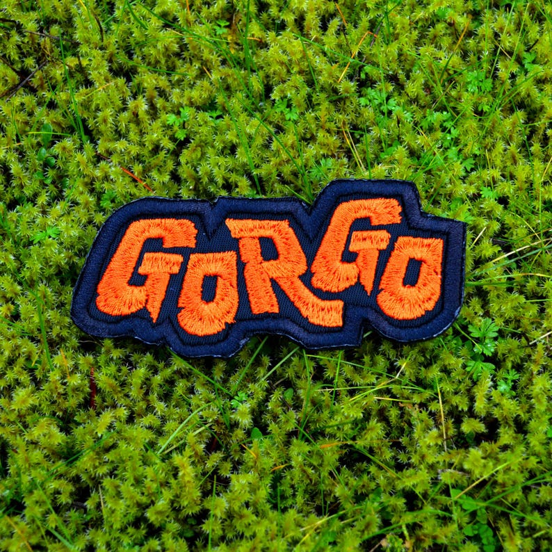 Orange and black embroidered logo patch for the classic Kaiju monster movie Gorgo.