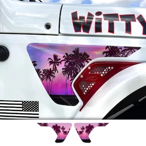 May include: White vehicle with a red accent and a black and white American flag sticker. The vehicle features a graphic of palm trees against a pink and purple sunset. The word "WITTY" is displayed in large black letters.