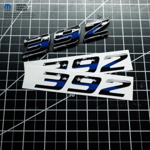 May include: Chrome-finished metal emblems and sticker decals featuring the number "392" with a blue stripe and star accents. The emblems have a glossy finish, while the stickers are white with black and blue details. The image includes the text "OFFICIAL LICENSED PRODUCT".