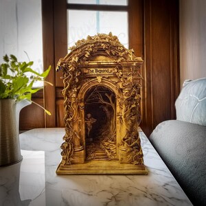 May include: A wooden sculpture of an archway with intricate carvings and vines. The archway is labelled "The Beyond" and depicts a dark, wooded path.