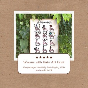 May include: A framed art print with a white background and black text that reads "WORMS WITH HATS". The print features a series of cartoon worms wearing different hats, such as a chef's hat, a graduation cap, and a cowboy hat. Each worm is labeled with a name, such as "Chef Worm" and "Sporty Worm".