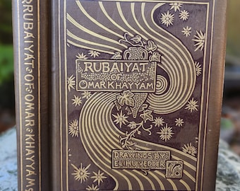 May include: A brown book with gold lettering on the cover. The title is "Rubaiyat of Omar Khayyam". The book has a decorative design with stars and vines.