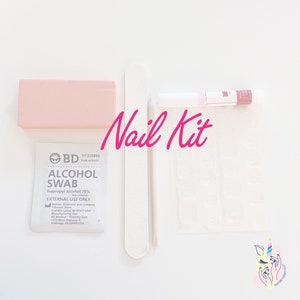 May include: A nail kit containing a pink buffer, a white nail file, a tube of nail glue, and an alcohol swab. The words "Nail Kit" are written in pink script across the image.