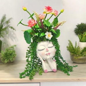 Flickaansikte-planteringsburk med suckulenter och sidenblommor