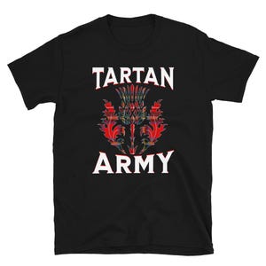 May include: Black t-shirt featuring the text "TARTAN ARMY" in white block letters above and below a colorful thistle emblem. The thistle design incorporates red, green, and yellow tartan patterns.