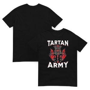 May include: Black t-shirt with the text "TARTAN ARMY" and a thistle design in red, green, and yellow tartan. The shirt is displayed with a second black t-shirt in the background.