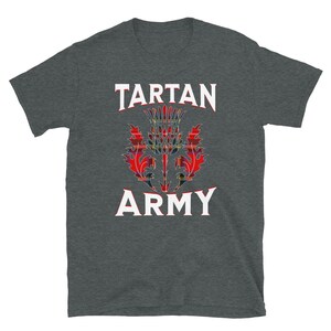 May include: Dark gray t-shirt featuring the text "TARTAN ARMY" in white, with a red, black, and yellow thistle design in the center. The shirt is a short-sleeved crew neck.