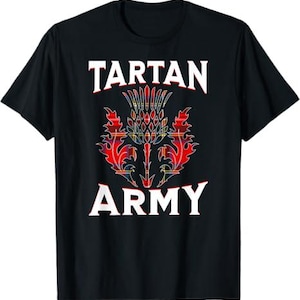 May include: Black t-shirt featuring the words "TARTAN ARMY" in white block letters above and below a colorful thistle design. The thistle is red, yellow, and blue.