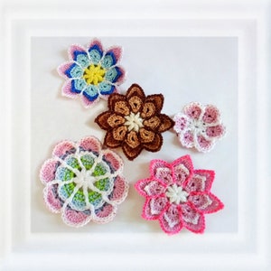 May include: Five handcrafted crochet flower appliques in various sizes and colors. The collection includes a multi-colored pastel flower, a solid brown flower, a small pink and white flower, a large circular floral motif, and a bright pink flower.