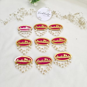 Beautifully designed Ladkiwale wedding brooches with pearl chains, perfect for the bride and groom's families. These brooches add a touch of glamour to any wedding function and make excellent bridal party gifts.