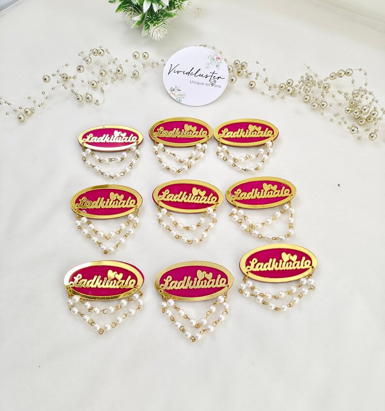 Beautifully designed Ladkiwale wedding brooches with pearl chains, perfect for the bride and groom's families. These brooches add a touch of glamour to any wedding function and make excellent bridal party gifts.