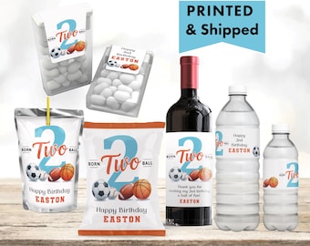 May include: A collection of birthday party supplies featuring a sports theme. Includes water bottles, a wine bottle, candy containers, and snack bags. Each item has a large number "2", sports balls, and the text "Happy 2nd Birthday EASTON".