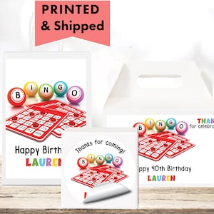 May include: White party favor boxes, stickers, and a card featuring bingo balls and cards. The text includes "Happy Birthday LAUREN", "Thanks for coming!", and "Happy 40th Birthday LAUREN".