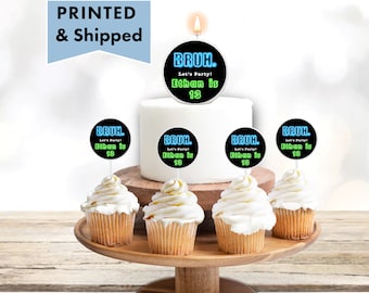 May include: A set of five black and white round cake toppers with neon blue and green text that reads "BRUH. Let's Party! Ethan is 13". The toppers are on cupcakes and a cake.