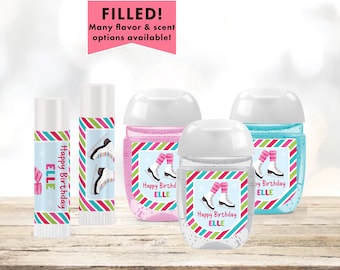 May include: Set of four personalized hand sanitizer bottles and two lip balm tubes with labels featuring a girl ice skating. The labels have a striped background with pink, green, blue, and white stripes. The text on the labels reads "Happy Birthday Elle".