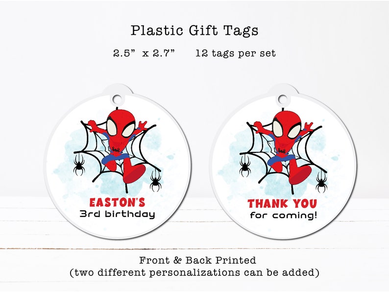 a pair of plastic tags with a spider on them