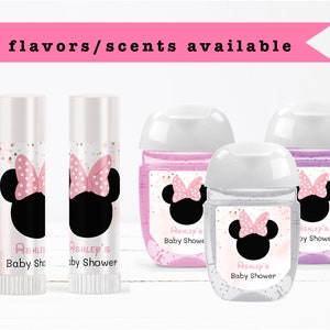 May include: Three clear plastic bottles with labels featuring a pink and white Minnie Mouse design. The labels also include the text "Ashley's Baby Shower". Two smaller white tubes with labels featuring a pink and white Minnie Mouse design. The labels also include the text "Ashley's Baby Shower".