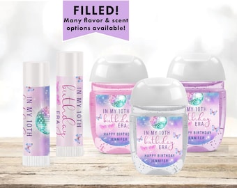May include: Four personalized hand sanitizer bottles and lip balm tubes with a holographic disco ball and butterfly design. The labels say "In my 10th birthday era" and "Happy Birthday Jennifer".