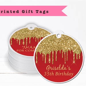 May include: Round red and gold glitter gift tags with the text "Griselda's 35th Birthday" printed on them. The tags have a hole punched at the top for string or ribbon.