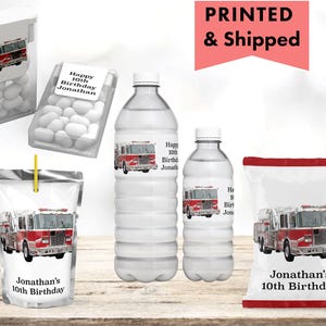 May include: A white ceramic mug with a black handle and the text "But First, Coffee" in a black, handwritten-style font. The mug is on a white surface.